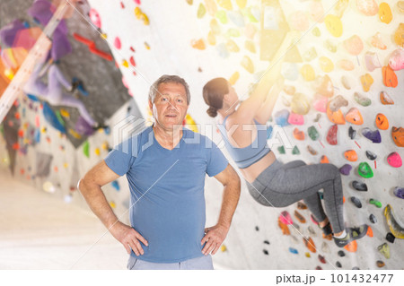 Adult man posing on climbing wall Adult man posing on climbing wall 101432477