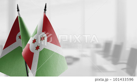 Small flags of the Burundi on an abstract blurry background 101433596