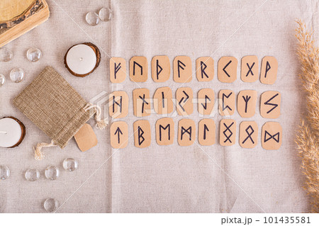 A set of homemade runes made of cardboard lies in rows on the table top view 101435581