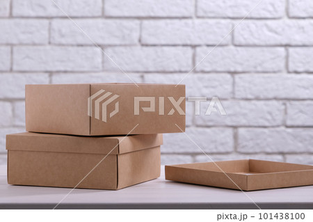 Two kraft cardboard boxes on the table Two kraft cardboard boxes on the table 101438100