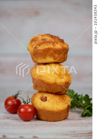 Savory muffin with ham and cheese on blue background 101438343