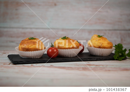 Savory muffin with ham and cheese on blue background Savory muffin with ham and cheese on blue background 101438367