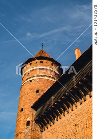 Old teutonic historical castle in Olsztyn Gothic Crusaders castle, tourist attraction of eastern Poland. Yellow orange brick wall with wooden decoration Old teutonic historical castle in Olsztyn Gothic Crusaders castle, tourist attraction of eastern Poland. Yellow orange brick wall with wooden decoration 101438578