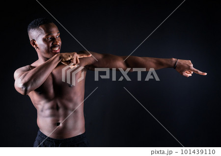 One young african muscular build man standing topless silhouette isolated on black background One young african muscular build man standing topless silhouette isolated on black background 101439110