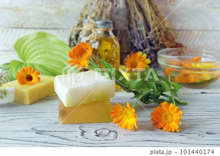 Calendula flowers, soap, oils and tinctures, on a wooden background, natural ingredients 101440174