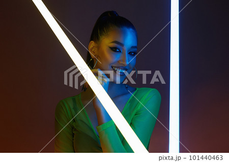 beautiful happy woman with neon lamp. Pretty Smiling girl 101440463