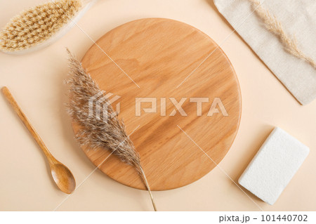 Empty wooden plate with dry herbs, SPA, bath accessories. Natural skin beauty product design. Organic cosmetics. Beige background. Flat lay, Top view Empty wooden plate with dry herbs, SPA, bath accessories. Natural skin beauty product design. Organic cosmetics. Beige background. Flat lay, Top view 101440702