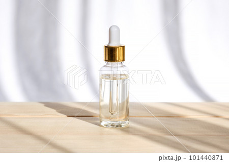 Natural oil cosmetics. Dropper glass Bottle Mock-Up. Oily cosmetic pipette. Face and body treatment. Spa concept. Beauty products. Blank packaging Natural oil cosmetics. Dropper glass Bottle Mock-Up. Oily cosmetic pipette. Face and body treatment. Spa concept. Beauty products. Blank packaging 101440871