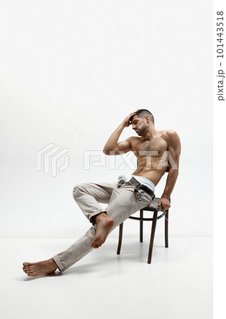 Sexy portrait of muscular handsome topless male model posing at camera over white studio background. Power, masculinity, strength Sexy portrait of muscular handsome topless male model posing at camera over white studio background. Power, masculinity, strength 101443518