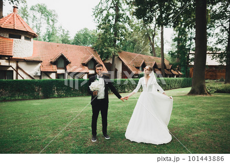 Wedding couple holding hands, groom and bride together on wedding day 101443886