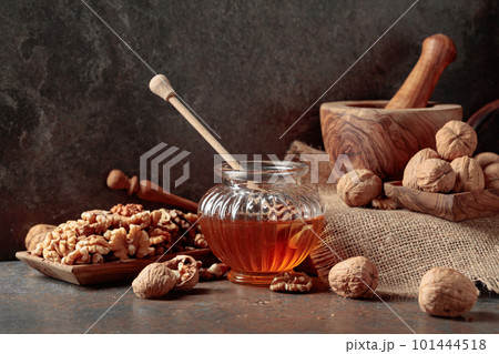 Honey and walnuts on a kitchen table. Honey and walnuts on a kitchen table. 101444518
