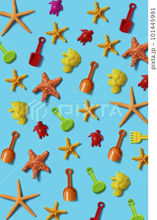 starfish and beach toys on a blue background starfish and beach toys on a blue background 101445991