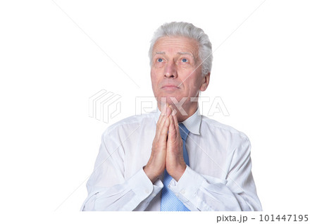 Portrait of senior man praying 101447195