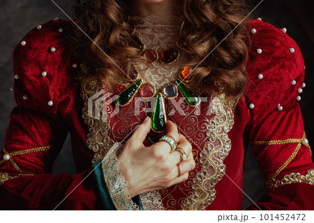 Closeup on medieval queen in red dress with jewellery Closeup on medieval queen in red dress with jewellery 101452472