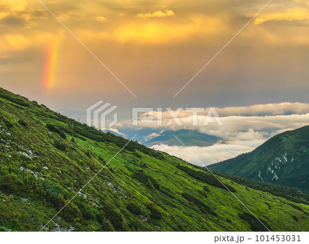 Rainbow and sunset clouds in Carpathian mountains. Ukraine 101453031
