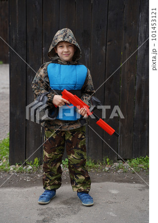 Heavily armed masked paintball soldier on post apocalyptic background. Ad concept. 101453121