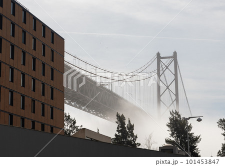Bridge shrouded in white fog and side of a modern building on the side Bridge shrouded in white fog and side of a modern building on the side 101453847