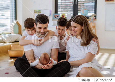 Big family with four kids enjoying their newborn baby. Big family with four kids enjoying their newborn baby. 101454772