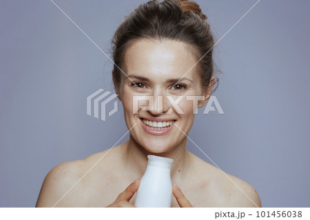 smiling modern 40 years old woman with cosmetic cream jar smiling modern 40 years old woman with cosmetic cream jar 101456038