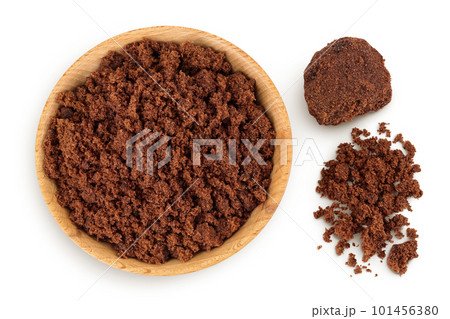 Dark muscovado sugar or Barbados sugar in wooden bowl isolated on white background. Top view. Flat lay 101456380