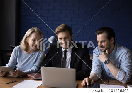 Positive confident different aged work group watching software product Positive confident different aged work group watching software product 101456809