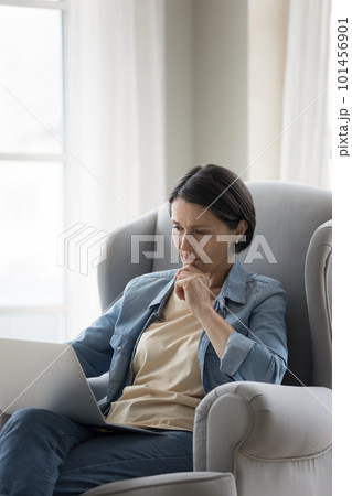 Serious pensive mature freelance woman working at laptop Serious pensive mature freelance woman working at laptop 101456901