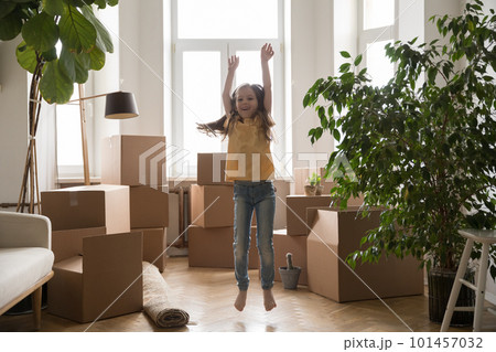 Happy excited kid girl playing among cardboard boxes 101457032