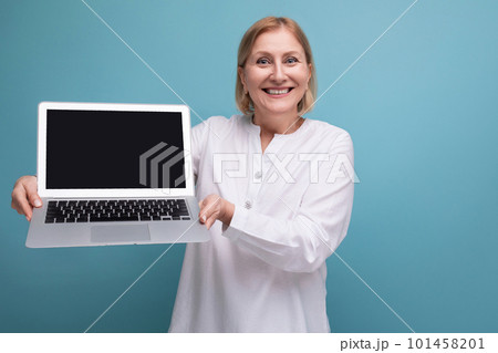 portrait of happy mature business woman with blond hair with laptop with screen template 101458201