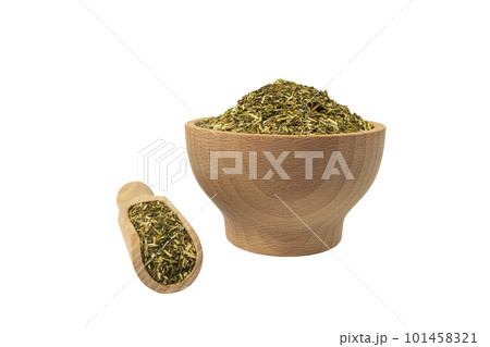 passion flower herb in latin - passiflora incarnata in wooden bowl and scoop isolated on white background. Medicinal herb. 101458321