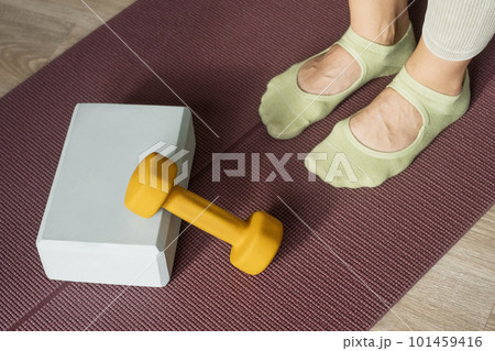 Workout and stretching accessories equipment in pilates studio. Yoga foam block, dumbbell and mat for fitness exercise. Healthy lifestyle. 101459416