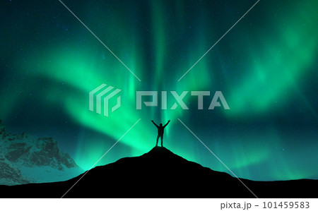 Northern lights and silhouette of man with raised up arms Northern lights and silhouette of man with raised up arms 101459583
