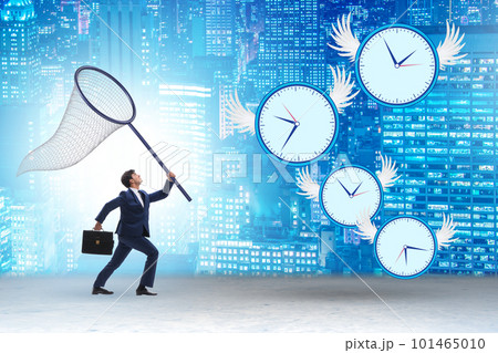 Deadline concept with businessman catching clocks 101465010