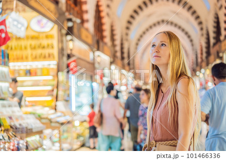 A tourist woman walks among the countless shops at the Grand Bazaar and Egyptian Bazaar in Istanbul. Shopping and travel in Turkey concept. Istanbul historical Egyptian Bazaar. Misir Carsisi, spice 101466336