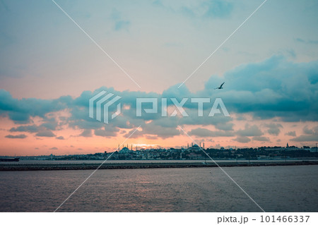 Istanbul at sunset, Turkey. Tourist boat sails on Golden Horn in summer. Beautiful sunny view of Istanbul waterfront with old mosque. Concept of travel, tourism and vacation in Istanbul and Turkey Istanbul at sunset, Turkey. Tourist boat sails on Golden Horn in summer. Beautiful sunny view of Istanbul waterfront with old mosque. Concept of travel, tourism and vacation in Istanbul and Turkey 101466337