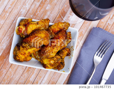 Fried chicken wings with golden crust served with on plate Fried chicken wings with golden crust served with on plate 101467735