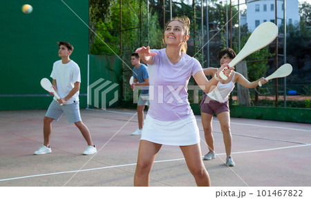 Woman playing Basque pelota on outdoor pelota court 101467822