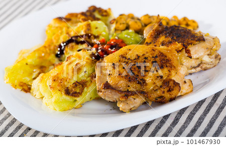 Roasted chicken thighs with cabbage in batter, chickpeas, sauces Roasted chicken thighs with cabbage in batter, chickpeas, sauces 101467930