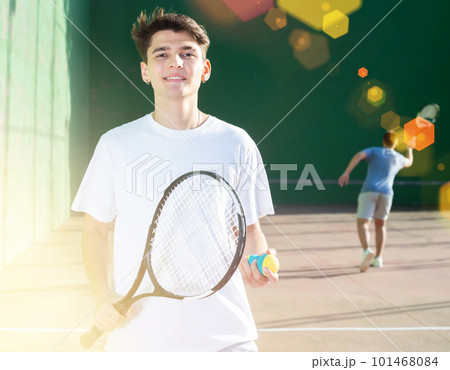 Portrait of positive young man frontenis player 101468084