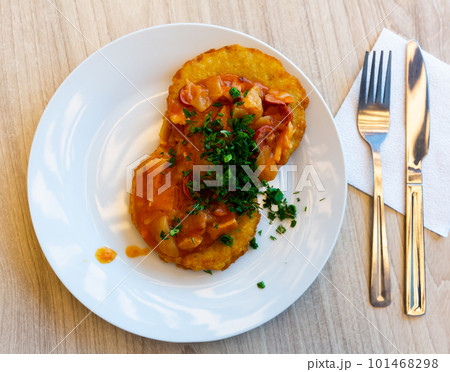 Belarusian draniki with vegetable and sausage stew Belarusian draniki with vegetable and sausage stew 101468298