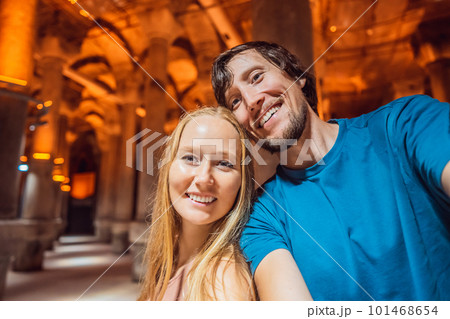 Happy couple enjoying Beautiful cistern in Istanbul. Cistern - underground water reservoir build in 6th century, Istanbul, Turkey, Turkiye Happy couple enjoying Beautiful cistern in Istanbul. Cistern - underground water reservoir build in 6th century, Istanbul, Turkey, Turkiye 101468654