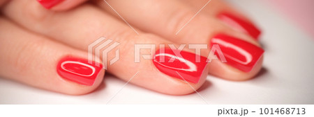 Woman hands with perfect bright red glossy manicure 101468713