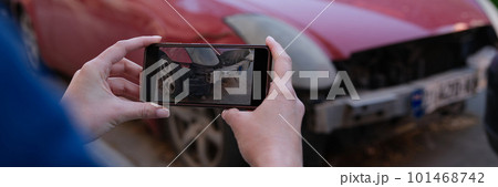 Female insurance broker making photos of car after accident on modern smartphone Female insurance broker making photos of car after accident on modern smartphone 101468742