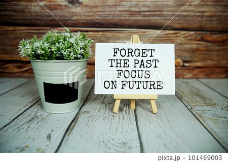"Forget The Past Focus on Future" Inspirational and motivational quote written on paper card 101469003