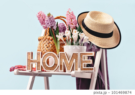 Home word. Several spring pink hyacinth flower plants potted on garden chair. Hat and apron. Flowerhead in bloom. Home Garden plants Home word. Several spring pink hyacinth flower plants potted on garden chair. Hat and apron. Flowerhead in bloom. Home Garden plants 101469874