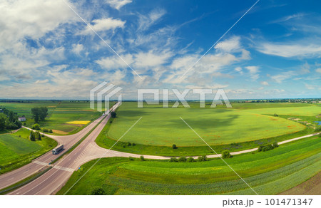 Summer rural landscape, aerial view. View of green fields, forest, village and highway Summer rural landscape, aerial view. View of green fields, forest, village and highway 101471347