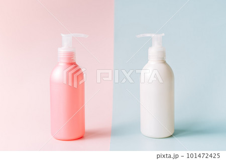 Tubes with dispenser against pink and blue background 101472425