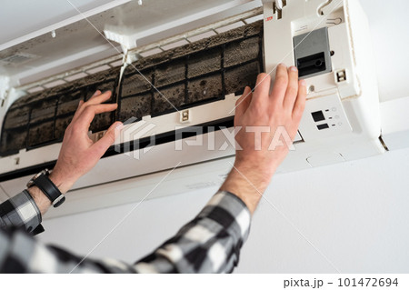 Air conditioner filter dusty. Preparation for maintenance and cleaning. Air conditioner filter dusty. Preparation for maintenance and cleaning. 101472694
