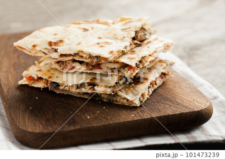 pile of quesadillas with chicken and vegetables on the rustic board pile of quesadillas with chicken and vegetables on the rustic board 101473239