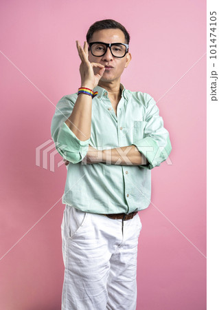 Man with eyeglasses and a shirt showing a rainbow bracelet 101474105