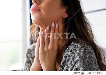 Female checking thyroid gland by herself Female checking thyroid gland by herself 101474986